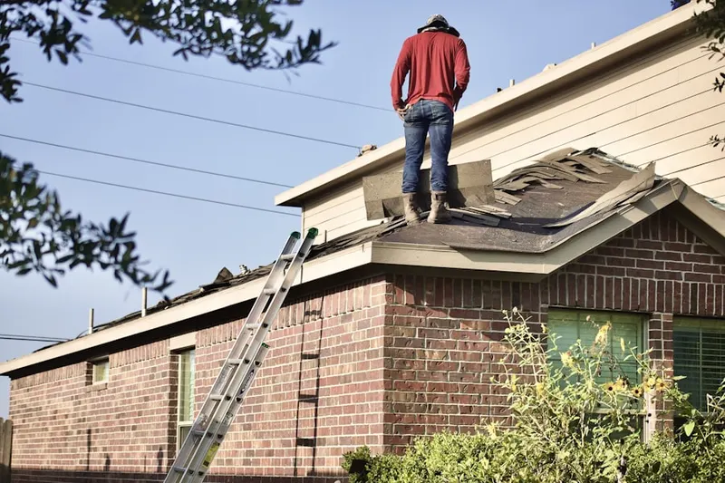 Professional roofer working on a residential roof in Howertown